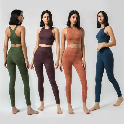 As mulheres o Activewear do Gym que da cobertura total ajusta a extremidade do impulso acima imprimiram caneleiras do Gym