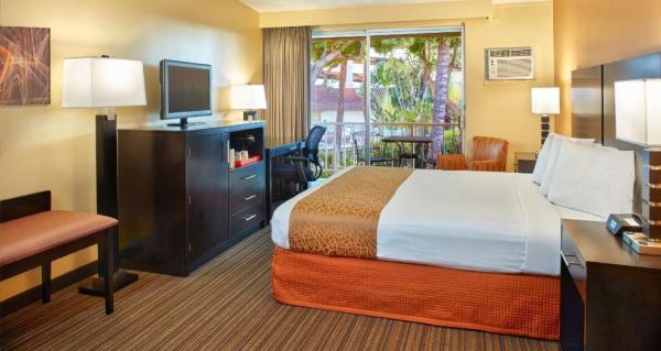 Jogja hotel interior design of guestroom furniture wood panel headboard and Drawer of TV cabinet with leisure chair