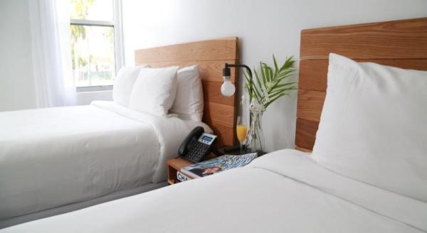 Phu Quoc Island travel vacation hotel guestroom oak wood bed with Nightstand and writing desk table wardrobe