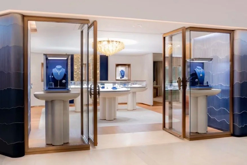 Modern Luxury Jewelry Showroom with Full-Store Custom Organic Curved-Pillar Display and Artistic Textured Wall Panels