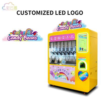 La machine à vendre de bonbons à couleur fonctionne avec une capacité de 5,6 kg.