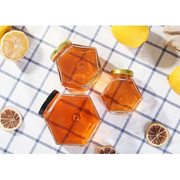 стеклянные опарникы меда 250ml-750ml с крышками, стеклом шестиугольника раздражают ясный цвет