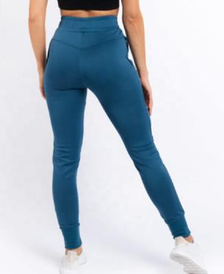 Das mulheres atléticas do Sweatpants das mulheres do esporte basculadores do treinamento