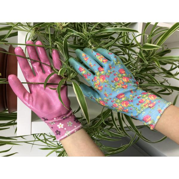 As mãos pequenas esverdeiam o nitrilo que mergulha luvas de jardinagem protetoras