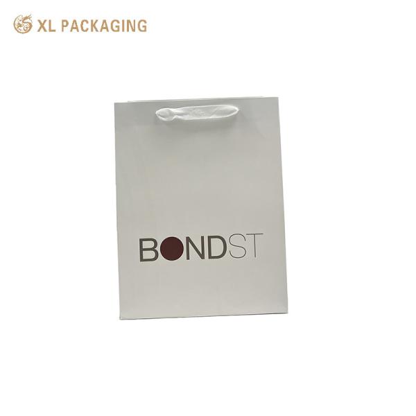 XL Packaging Custom Packaging Factory Professional Custom Paper Bag White Edge White One For Shopping Clothing Shoes Packing Shopping Bag With Logo