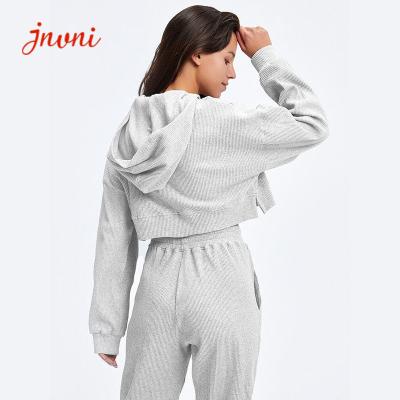 A parte superior da luva e as mulheres longas das caneleiras malham Hoodies com os equipamentos de duas partes do bolso