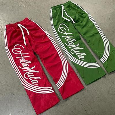 Coupe-vent en nylon rayures latérales Sweatpants légers sac à main large jambes coureur d'écran de soie Impression d'écran d'homme rapidement sec Pantalons