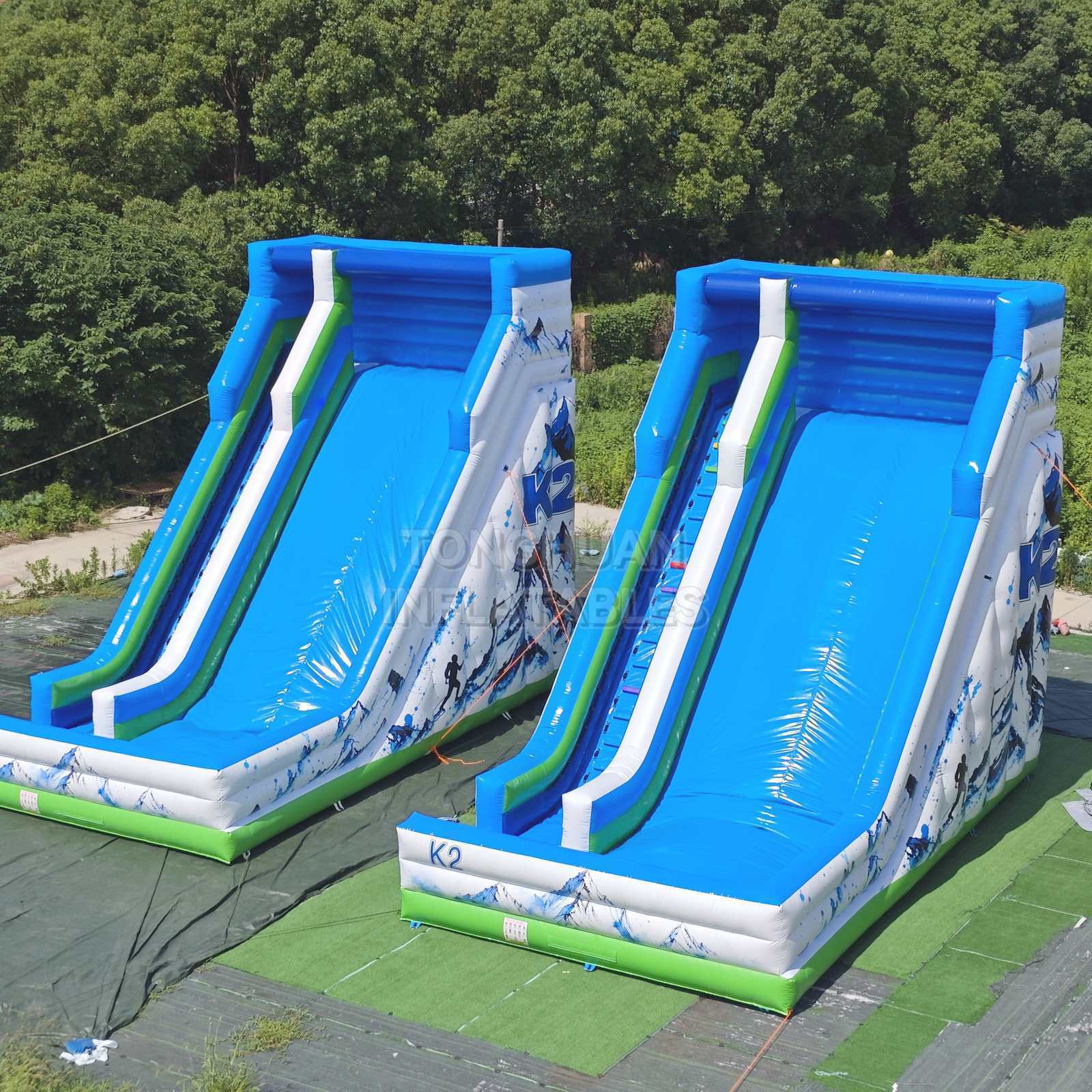 Commercial K2 Double Lane Inflatable Slide with Mountain Graphics High Side Walls and Safety Landing Areas for Parks Events and Rentals