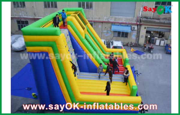 Infláveis gigantes deslizam a corrediça inflável colorida do leão-de-chácara de 9.5*7.5*6.5m com a parede de escalada para o parque de diversões