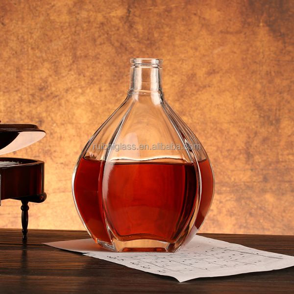 Fabricación personalizada de botellas de vidrio de estampado caliente para tipos irregulares de whisky y vodka