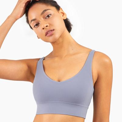 O sutiã profundo dos esportes do decote em V do Spandex de nylon recolheu a pele amigável