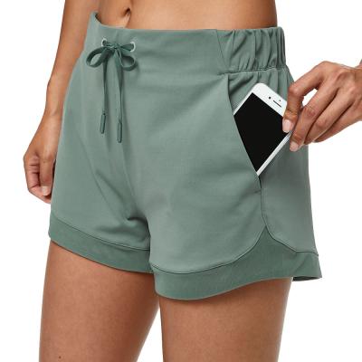 As mulheres que o verão afrouxa esportes atléticos secos rápidos malham o short com bolsos
