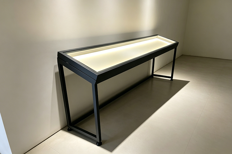 Long Narrow Museum Display Table With Gas-Strut Lift Mechanism And LED Illuminated Platform In Anti-Glare Low-Iron Glass