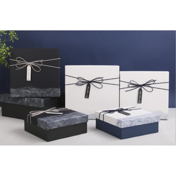 Las cajas de regalo de la Navidad del paquete plano reciclaron los materiales blancos de la cartulina con la cinta