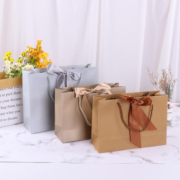 Sac shopping en papier avec nœud papillon pour cosmétiques, sac cadeau multicolore pour emballage de vêtements avec impression de logo