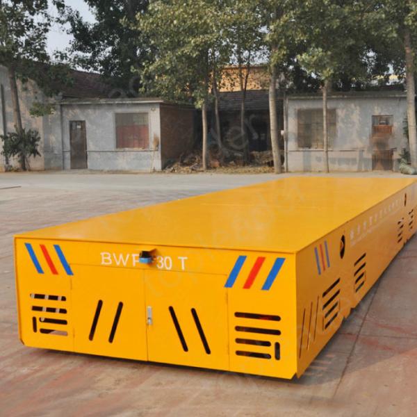 Battery operated steerable motorized trackless transfer car on cement floor