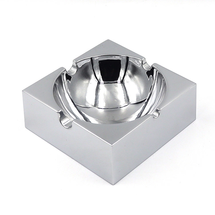 Square polished metal ashtray with glossy mirror surface and multiple notches for stable placement