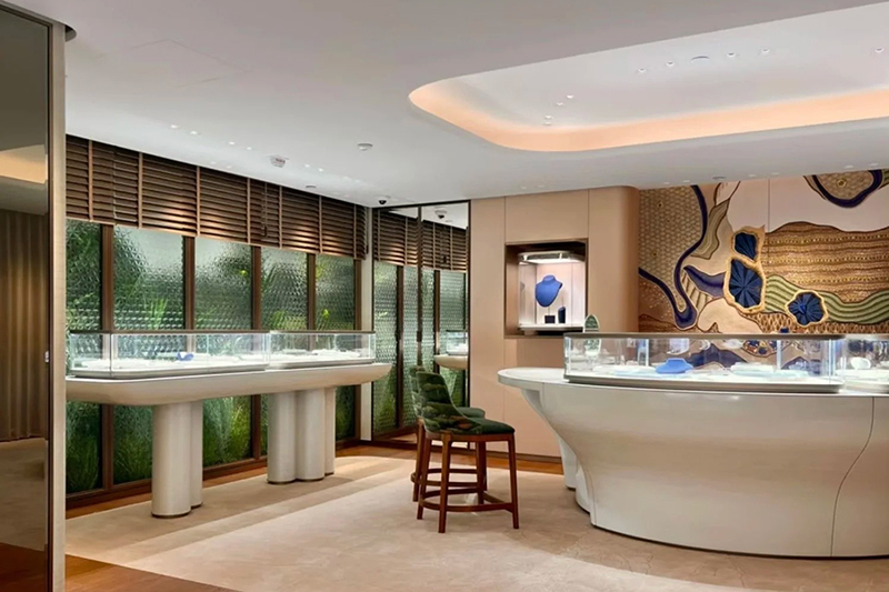 Modern Luxury Jewelry Showroom with Full-Store Custom Organic Curved-Pillar Display and Artistic Textured Wall Panels