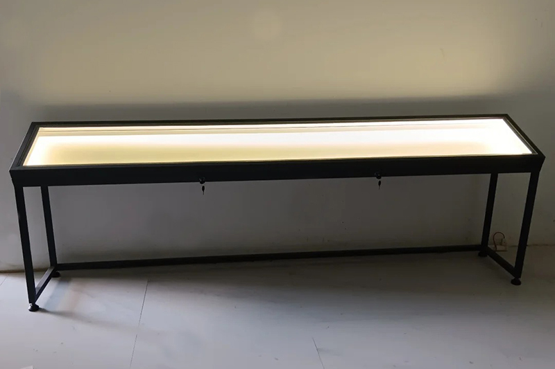 Long Narrow Museum Display Table With Gas-Strut Lift Mechanism And LED Illuminated Platform In Anti-Glare Low-Iron Glass