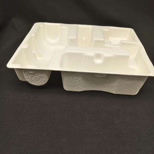 OEM manufacturers customize pulp molded packaging bases for small household appliance fascia guns. These are made of white plant fibers through dry pressing.