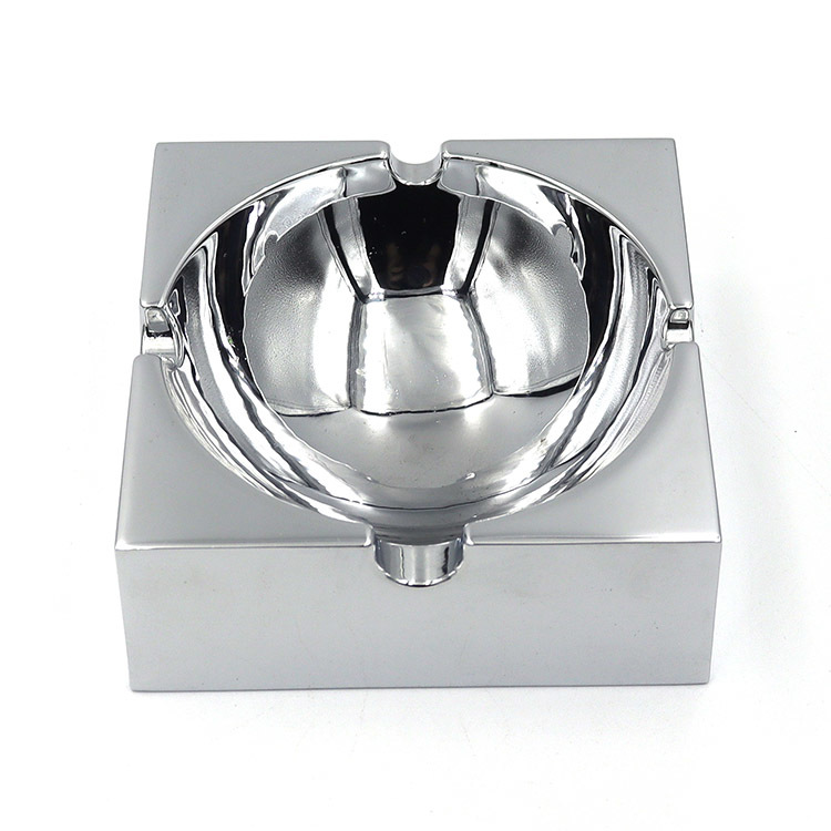 Square polished metal ashtray with glossy mirror surface and multiple notches for stable placement