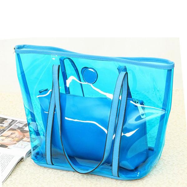 As sacolas transparentes das senhoras cancelam bolsas do PVC, alaranjado/vermelho/azul