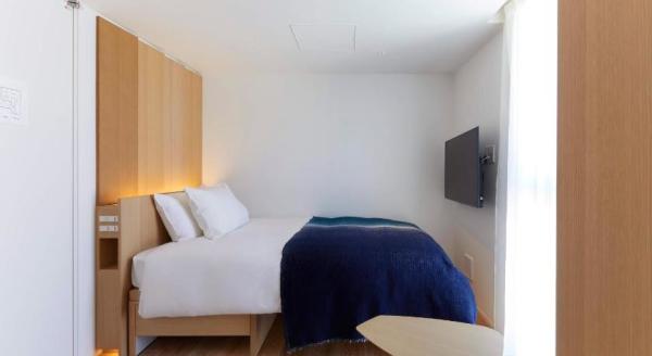 Perth hotel interior design FFE solution by laminate wood headboard bed with light luxury sofa and coffee table