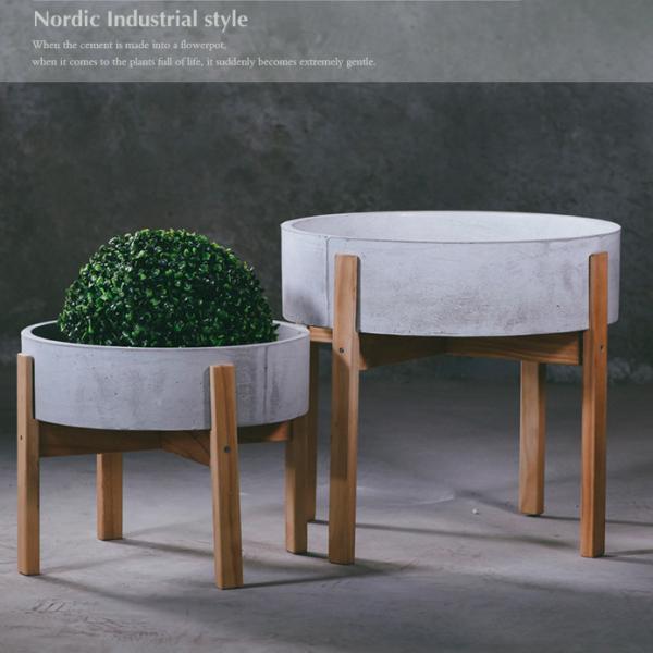 pan shaped concrete flower pot with a four legged wooden stand for flower bed indoor outdoor