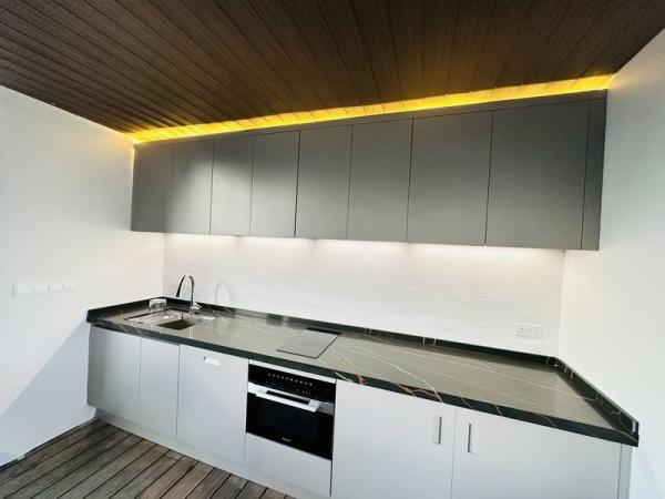 Armários de cozinha de aço inoxidável minimalista com bancadas de quartzo preto