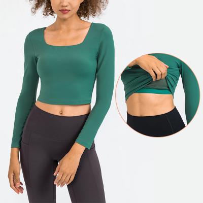 Das mulheres longas elásticas altas da luva das partes superiores da ioga das senhoras as camisas com sutiã