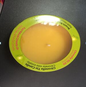 Yellow Citronella tin scented candle with the printed label shrinked