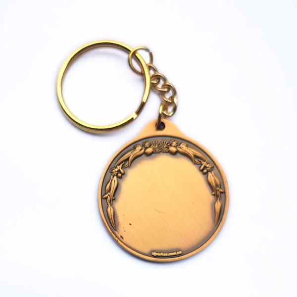 Des porte-clés métalliques en alliage de zinc ronde des porte-clés en or ancien