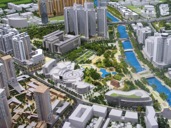 Modelo arquitectónico de planificación urbana moderna junto al río con distritos de gran altura y redes verdes