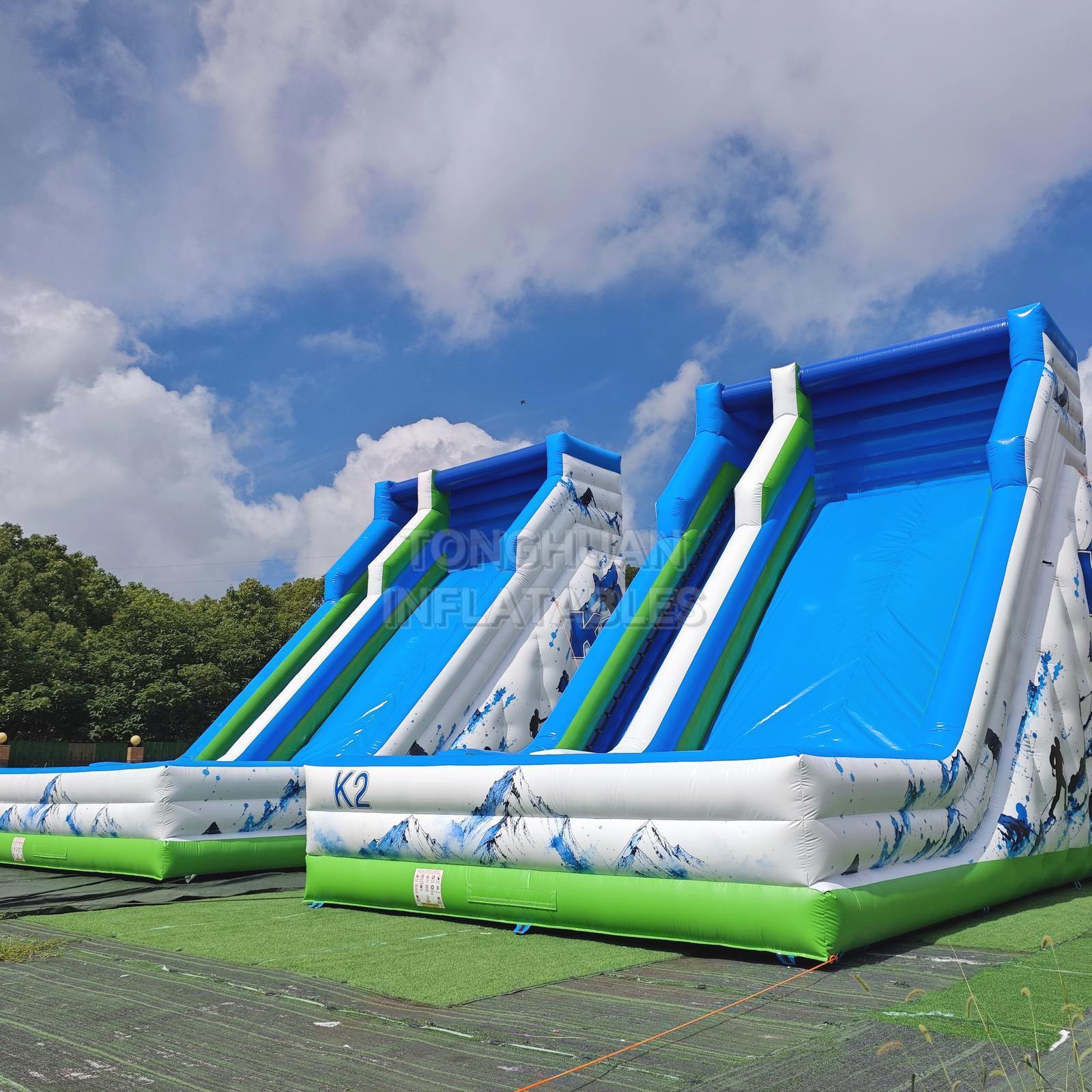 Commercial K2 Double Lane Inflatable Slide with Mountain Graphics High Side Walls and Safety Landing Areas for Parks Events and Rentals