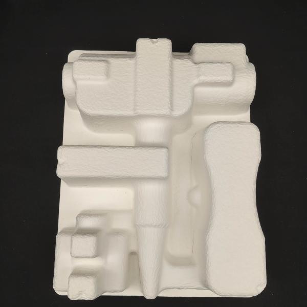 OEM manufacturers customize pulp molded packaging bases for small household appliance fascia guns. These are made of white plant fibers through dry pressing.