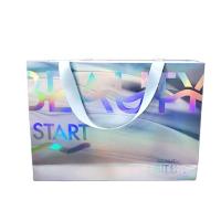 Boutique Sac en papier imprimé sur mesure Sac de magasinage holographique avec poignée de ruban