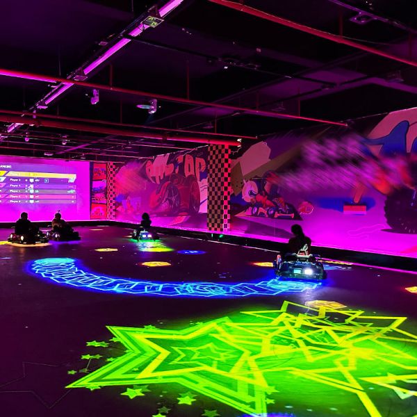 Dynamic Projection Karting: High-Precision AR Racing with Real-Time Interactive Effects