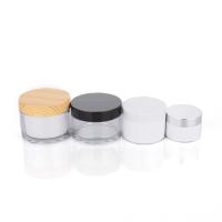 Bouteille en plastique transparent cylindrique de 100 g avec couvercle en bambou pour un pot de crème vide