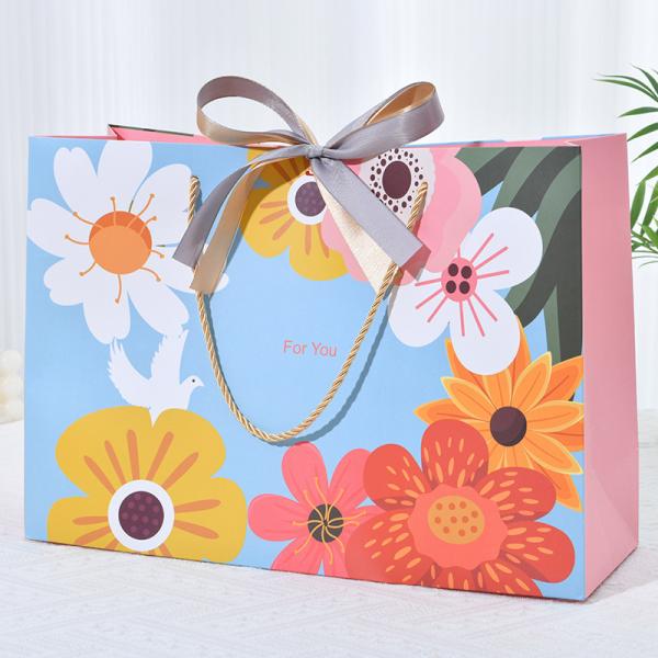 ​​Premium Floral Gift Bag With Gold Twine Handles Chic Bow Vibrant Blue Multicolor Bloom Design