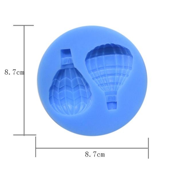 O bolo do fundente do silicone que decora utiliza ferramentas o balão de ar personalizado dado forma