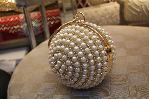 Round high-grade pearls evening bags woman holding a high-end fashion evening bag bride