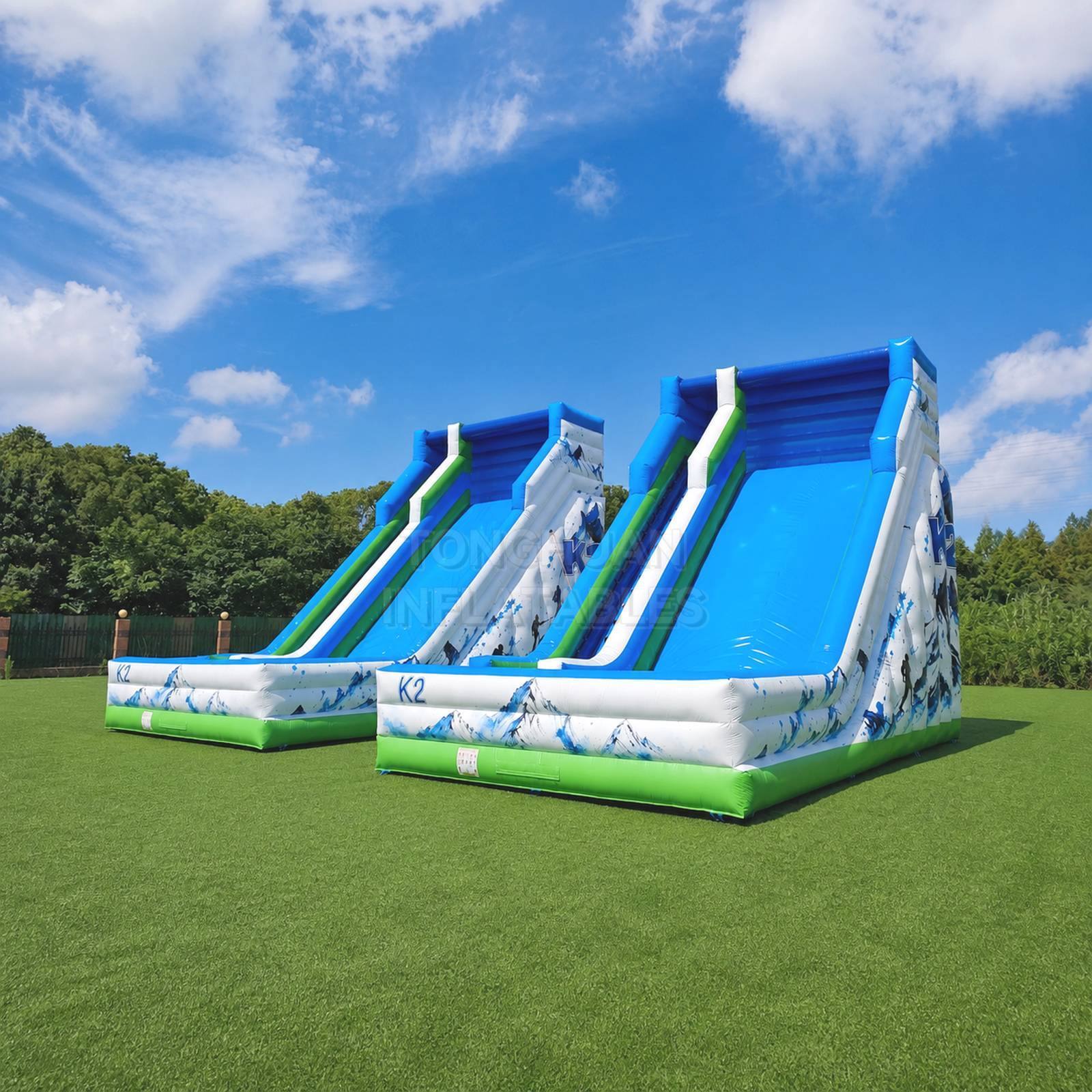 Commercial K2 Double Lane Inflatable Slide with Mountain Graphics High Side Walls and Safety Landing Areas for Parks Events and Rentals