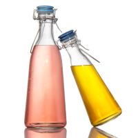 Venta al por mayor 250 ml 500 ml botellas redondas de vidrio de jugo botellas de vidrio de bebidas botella con tapa