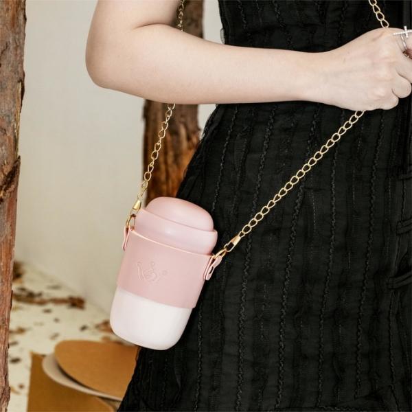 Stylish ceramic water bottle ceramic body gold-toned chain strap trendy design versatile style perfect for everyday