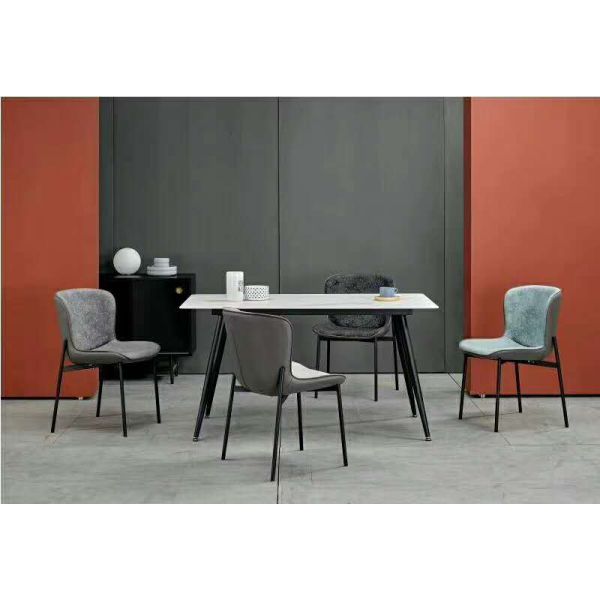 White Marble Dining Table With Angled And Black Powder Coated Steel Legs