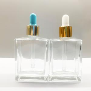 OEM 50ml 100mlの金が付いている化粧品の点滴器のびんはつばをよじ登る