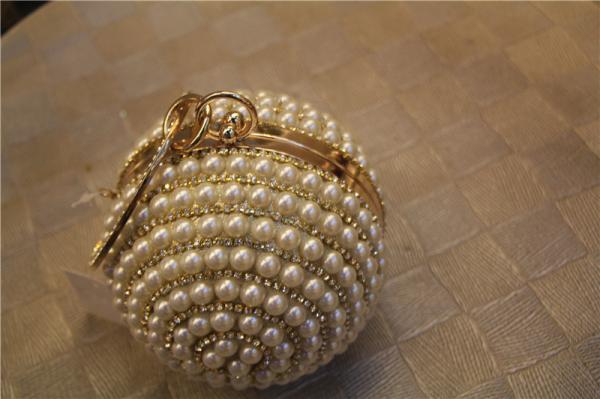 Round high-grade pearls evening bags woman holding a high-end fashion evening bag bride
