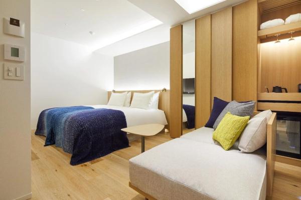 Perth hotel interior design FFE solution by laminate wood headboard bed with light luxury sofa and coffee table