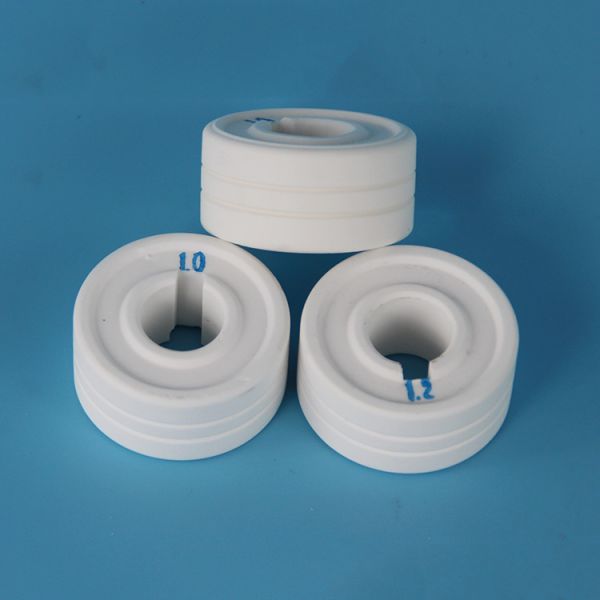 Corrosion resistant ceramics for alumina wire feeder