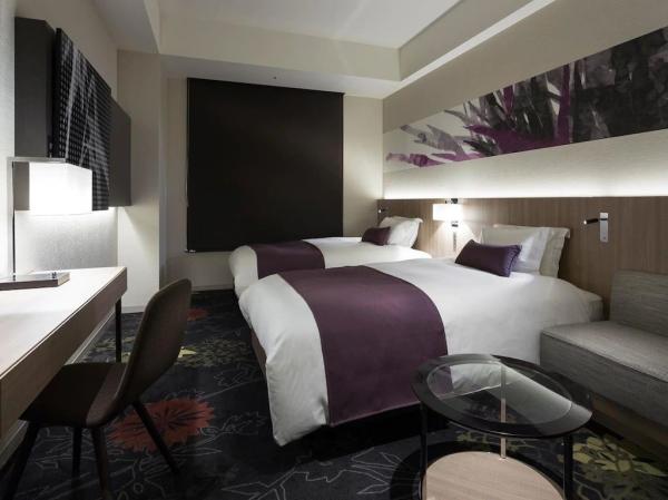 Palmerston North resort hotel inteior design furniture Laminate headboard with nightstand and fabric upholstered sofa